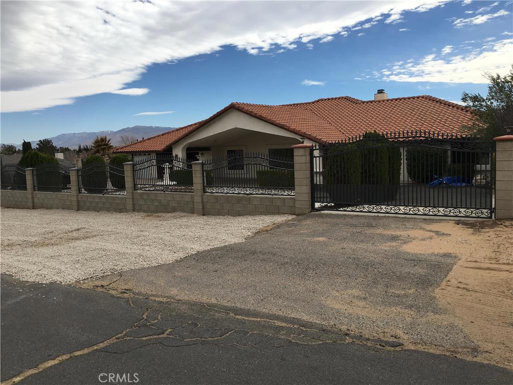20231 Wadena Road Apple Valley, CA 92308 - Photo 1 of 20 a front view of a house with a yard