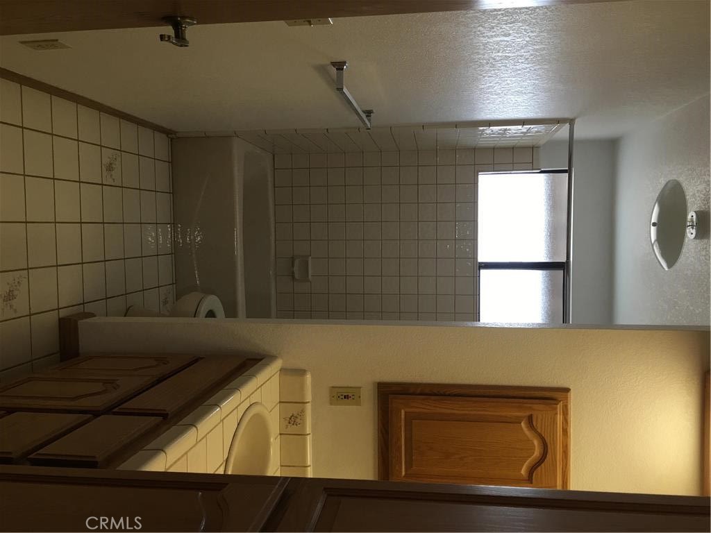 20231 Wadena Road Apple Valley, CA 92308 - Photo 8 of 20 a bathroom with a sink and a mirror