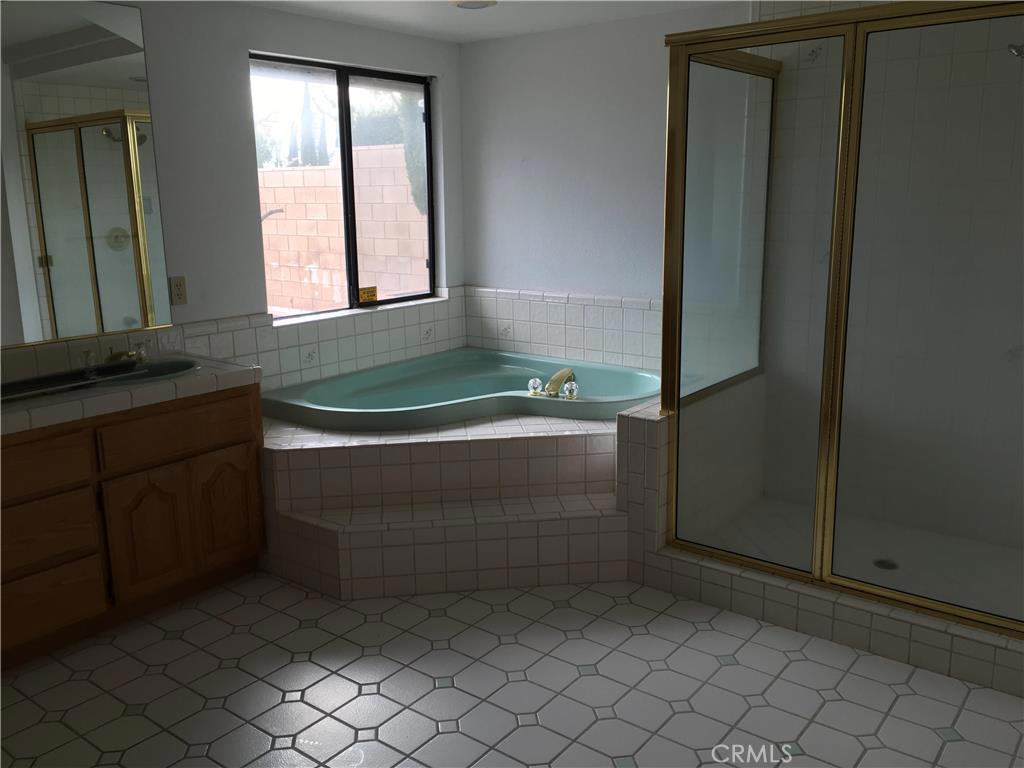 20231 Wadena Road Apple Valley, CA 92308 - Photo 10 of 20 a bathroom with a bathtub and shower
