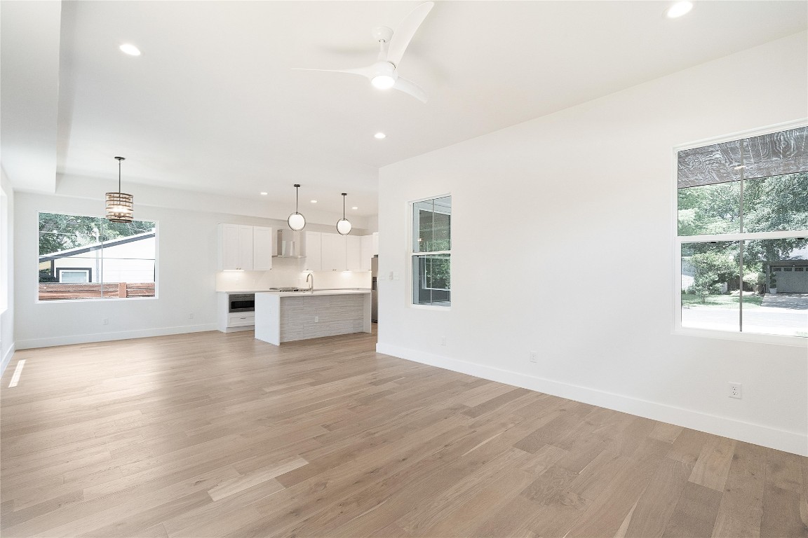 4805 Enchanted Lane, Unit 1 Austin, TX 78745 - Photo 13 of 29 wooden floor in an empty room with a window
