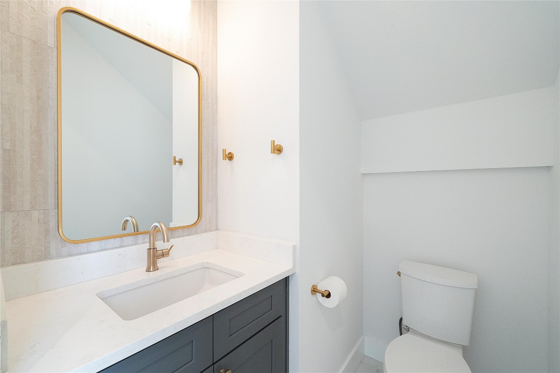 4805 Enchanted Lane, Unit 1 Austin, TX 78745 - Photo 14 of 29 a bathroom with a sink toilet and a mirror