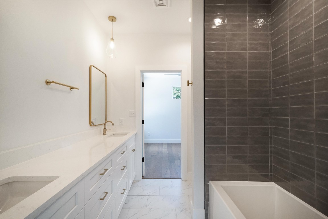 4805 Enchanted Lane, Unit 1 Austin, TX 78745 - Photo 17 of 29 a bathroom with a bathtub and a sink