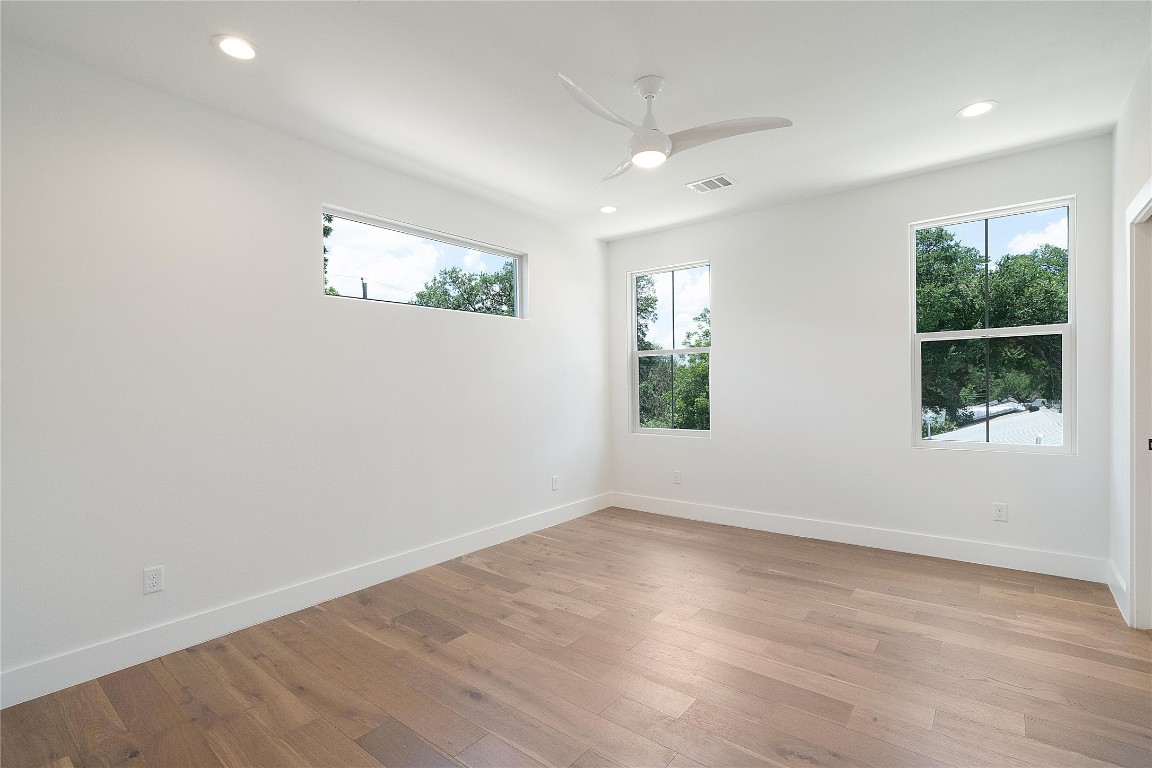 4805 Enchanted Lane, Unit 1 Austin, TX 78745 - Photo 22 of 29 an empty room with wooden floor and windows
