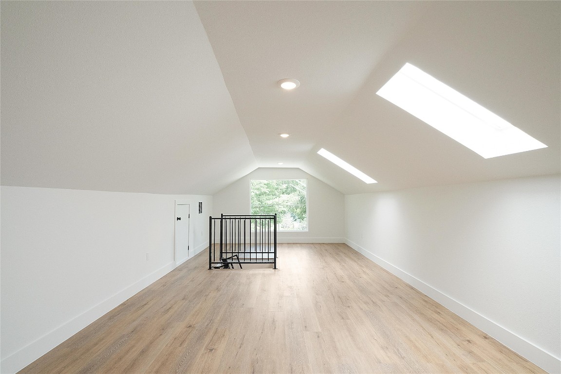 4805 Enchanted Lane, Unit 1 Austin, TX 78745 - Photo 28 of 29 an empty room with wooden floor and windows