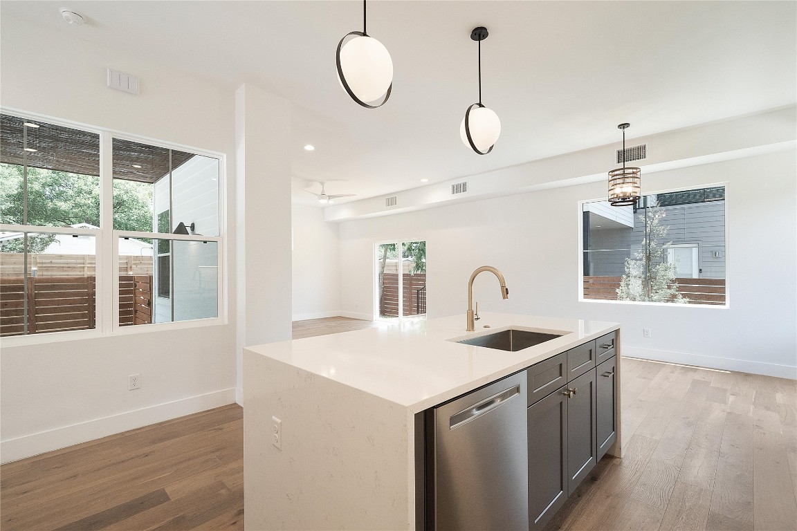4805 Enchanted Lane, Unit 1 Austin, TX 78745 - Photo 8 of 29 a kitchen that has a lot of white cabinets and wooden floor