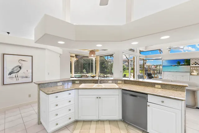 a large kitchen with sink and cabinets