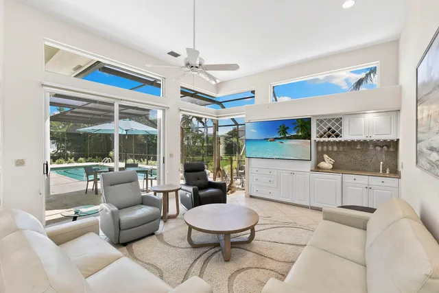 a living room with furniture a rug and white walls