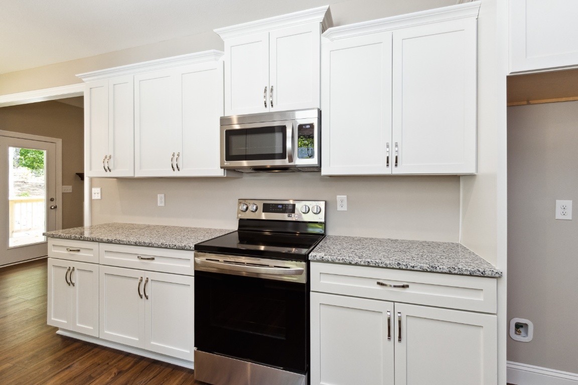 427 Jen Hollow Road Clarksville, TN 37040 - Photo 11 of 36 a kitchen with white cabinets and appliances