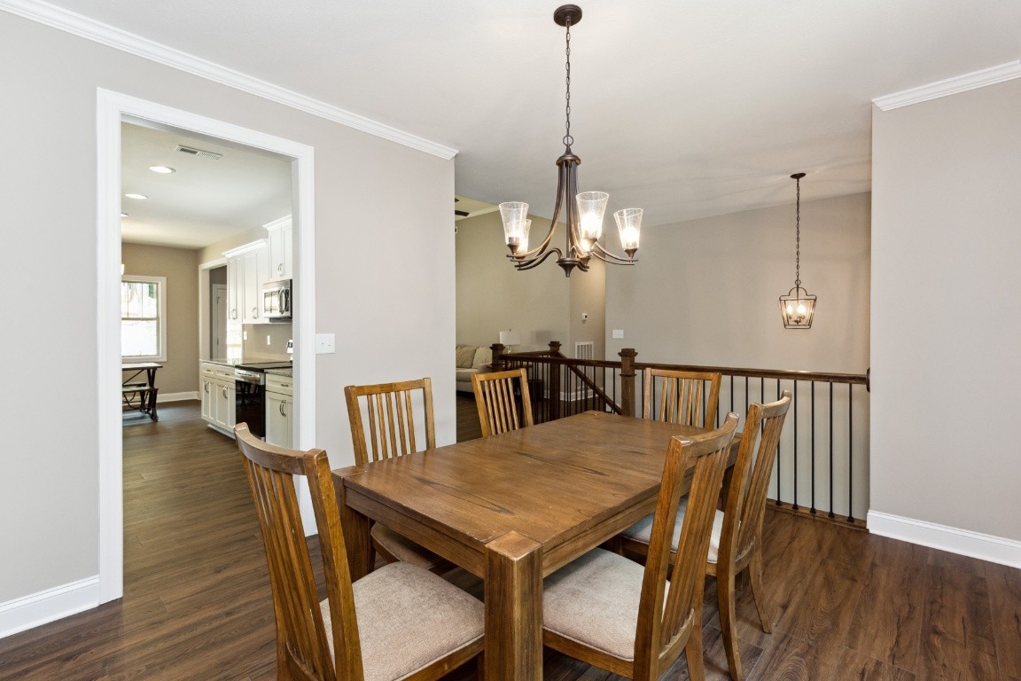 427 Jen Hollow Road Clarksville, TN 37040 - Photo 13 of 36 a view of a dining room and livingroom with furniture wooden floor a chandelier