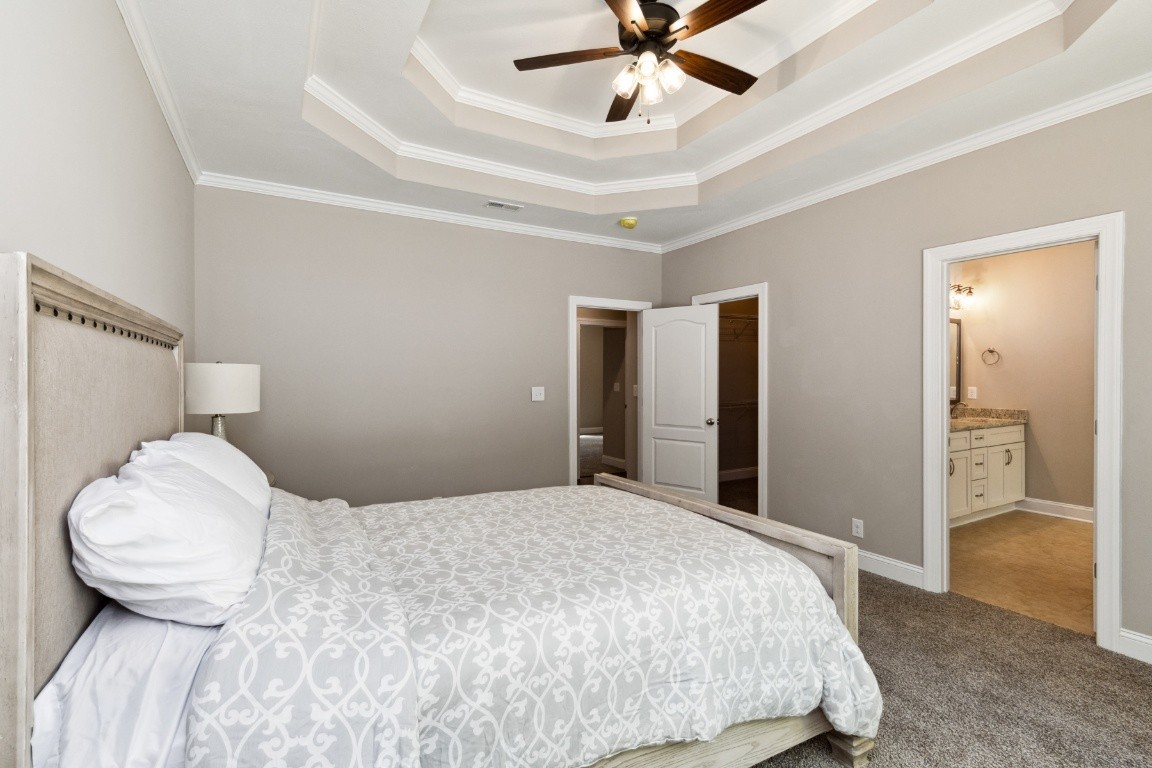 427 Jen Hollow Road Clarksville, TN 37040 - Photo 16 of 36 a bedroom with a large bed and a chandelier