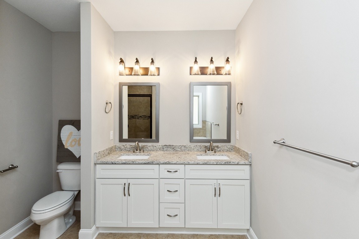 427 Jen Hollow Road Clarksville, TN 37040 - Photo 18 of 36 a bathroom with a granite countertop sink and a mirror