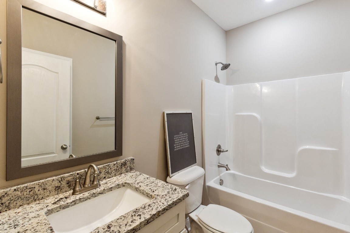 427 Jen Hollow Road Clarksville, TN 37040 - Photo 22 of 36 a bathroom with a granite countertop sink toilet and shower