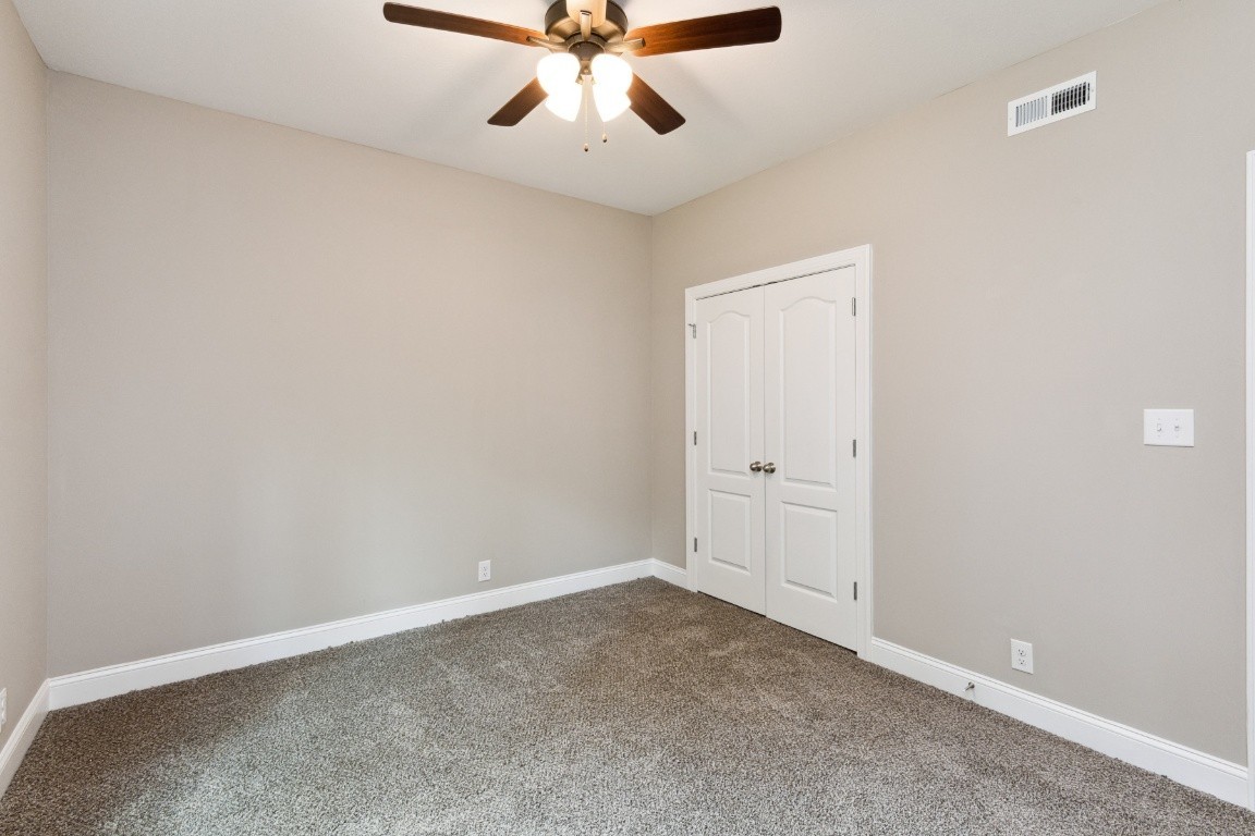 427 Jen Hollow Road Clarksville, TN 37040 - Photo 31 of 36 an empty room with a ceiling fan and carpet