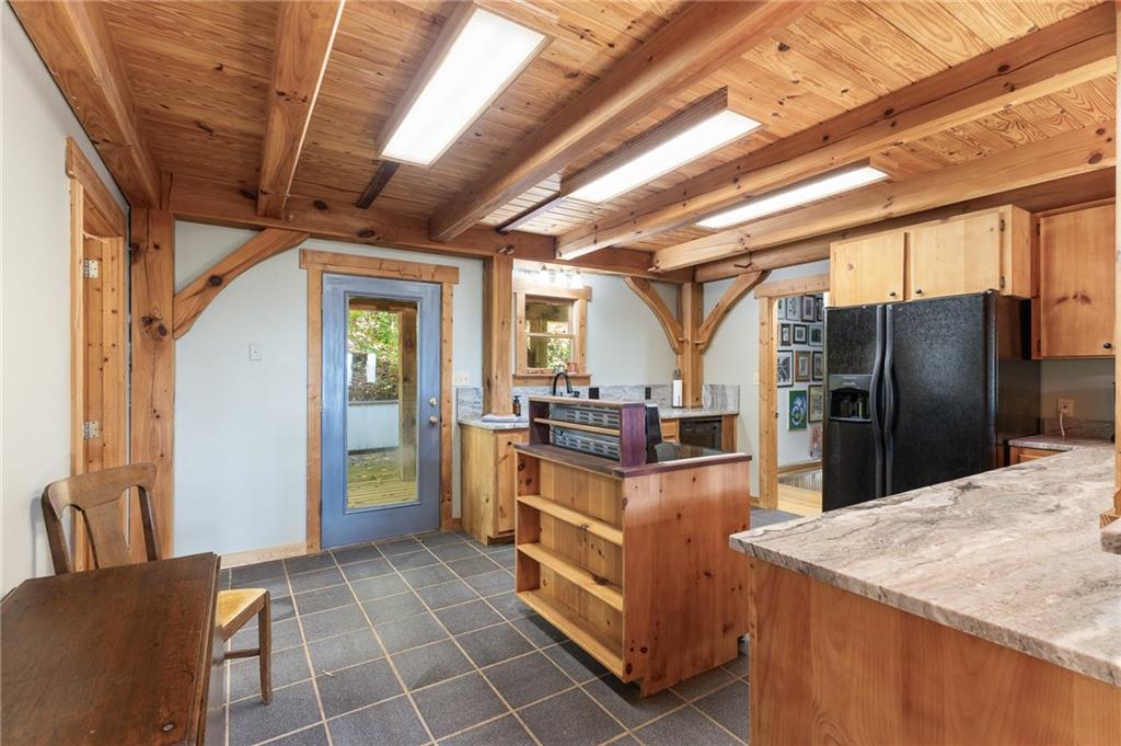 339 Cameron Road Cleveland, GA 30528 - Photo 18 of 36 a kitchen with granite countertop a refrigerator and a stove top oven