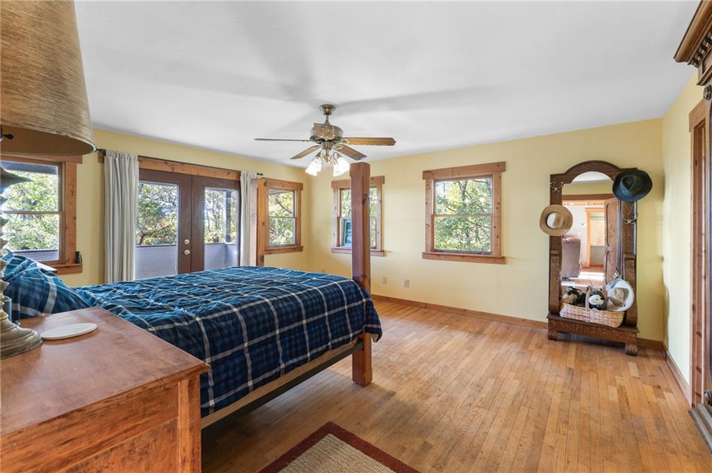 339 Cameron Road Cleveland, GA 30528 - Photo 23 of 36 a bedroom with a bed and a dresser next to a window