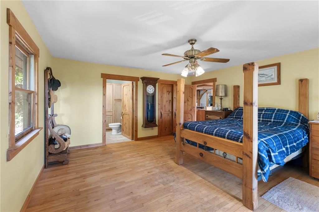 339 Cameron Road Cleveland, GA 30528 - Photo 24 of 36 a spacious bedroom with a bed and a chandelier