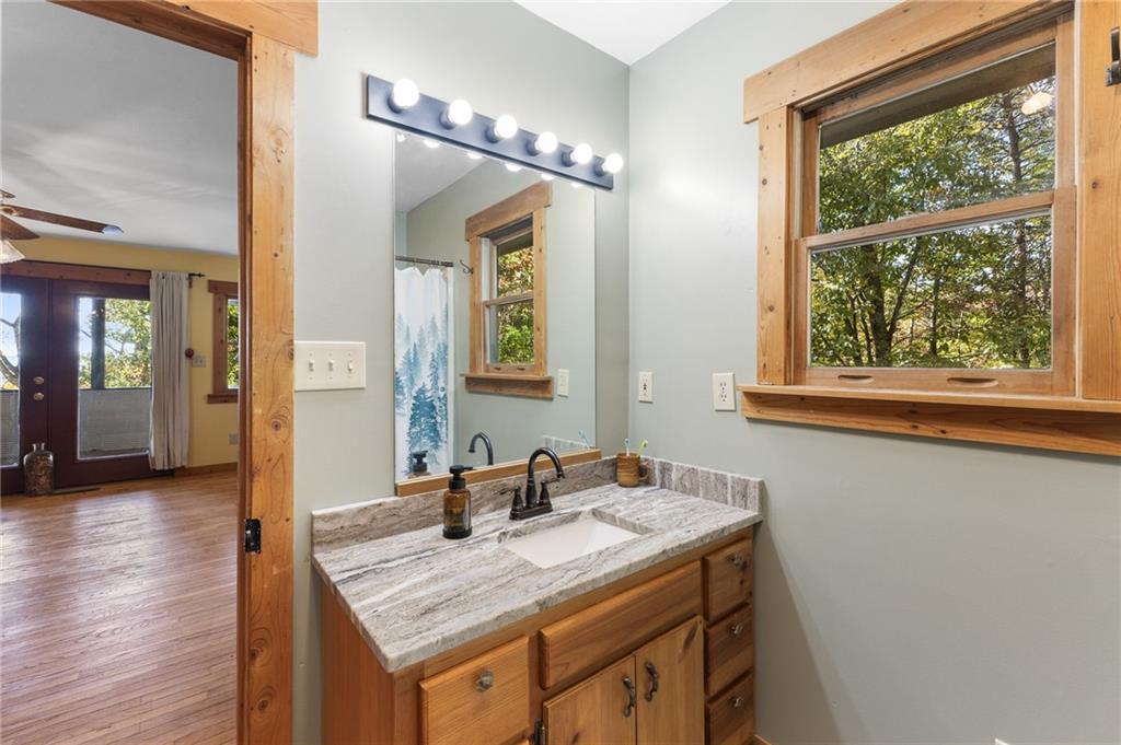 339 Cameron Road Cleveland, GA 30528 - Photo 25 of 36 a bathroom with a granite countertop sink and a mirror