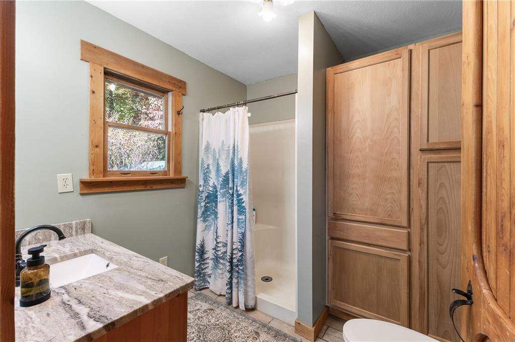 339 Cameron Road Cleveland, GA 30528 - Photo 26 of 36 a bathroom with a granite countertop sink and a mirror