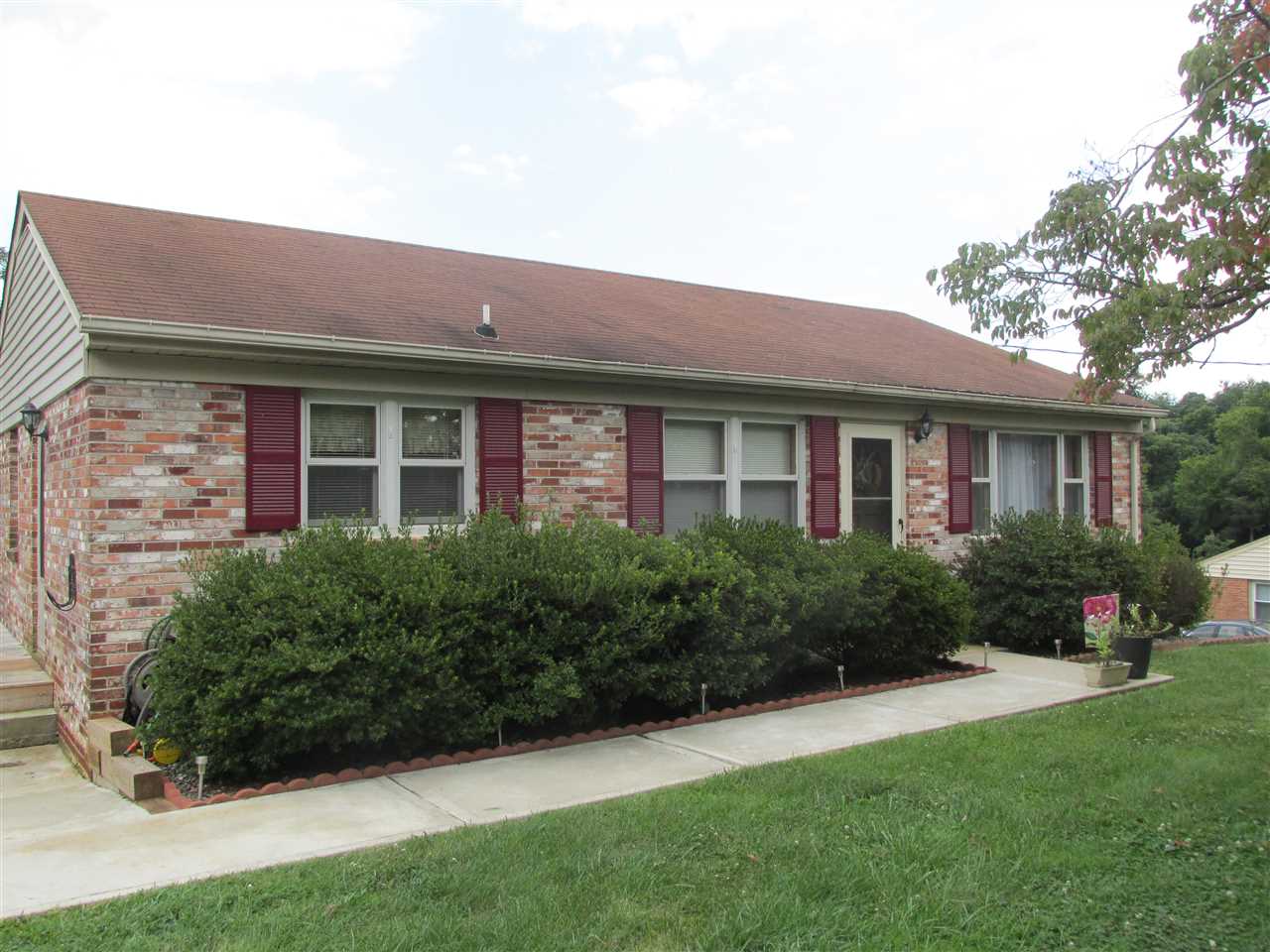 318 Locust Lane Ruckersville, VA 22968 - Photo 1 of 8 a front view of a house with porch and garden