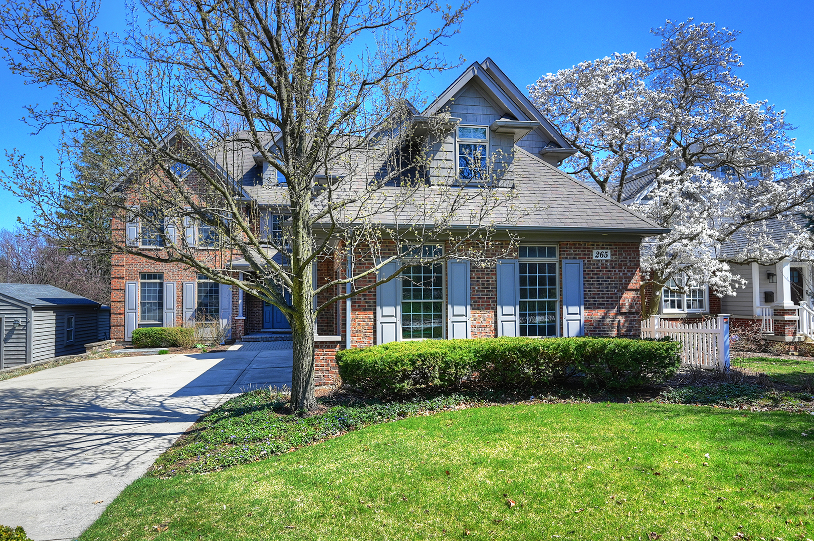 265 Holmes Avenue Clarendon Hills, IL 60514 - Photo 1 of 43 a front view of a house with a yard