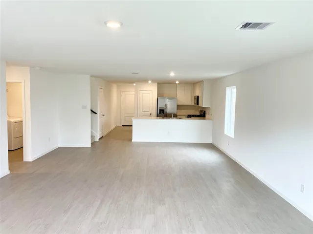 a view of a kitchen with a sink and a window