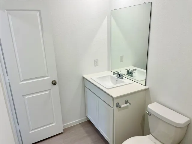 a bathroom with a sink toilet and vanity