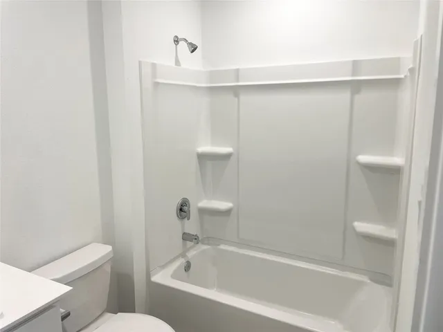 a bathroom with a bathtub and a toilet
