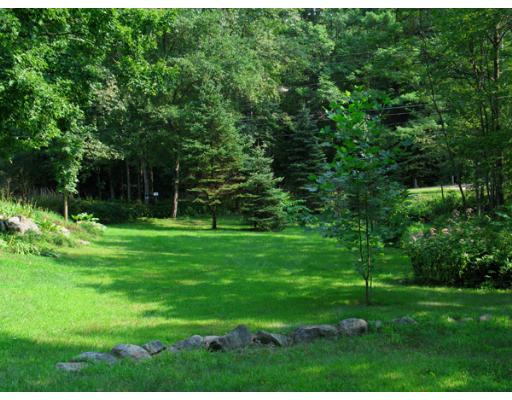 40 Chestnut Hill Road Orange, MA 01364 - Photo 5 of 22 a view of a grassy field with trees in the background