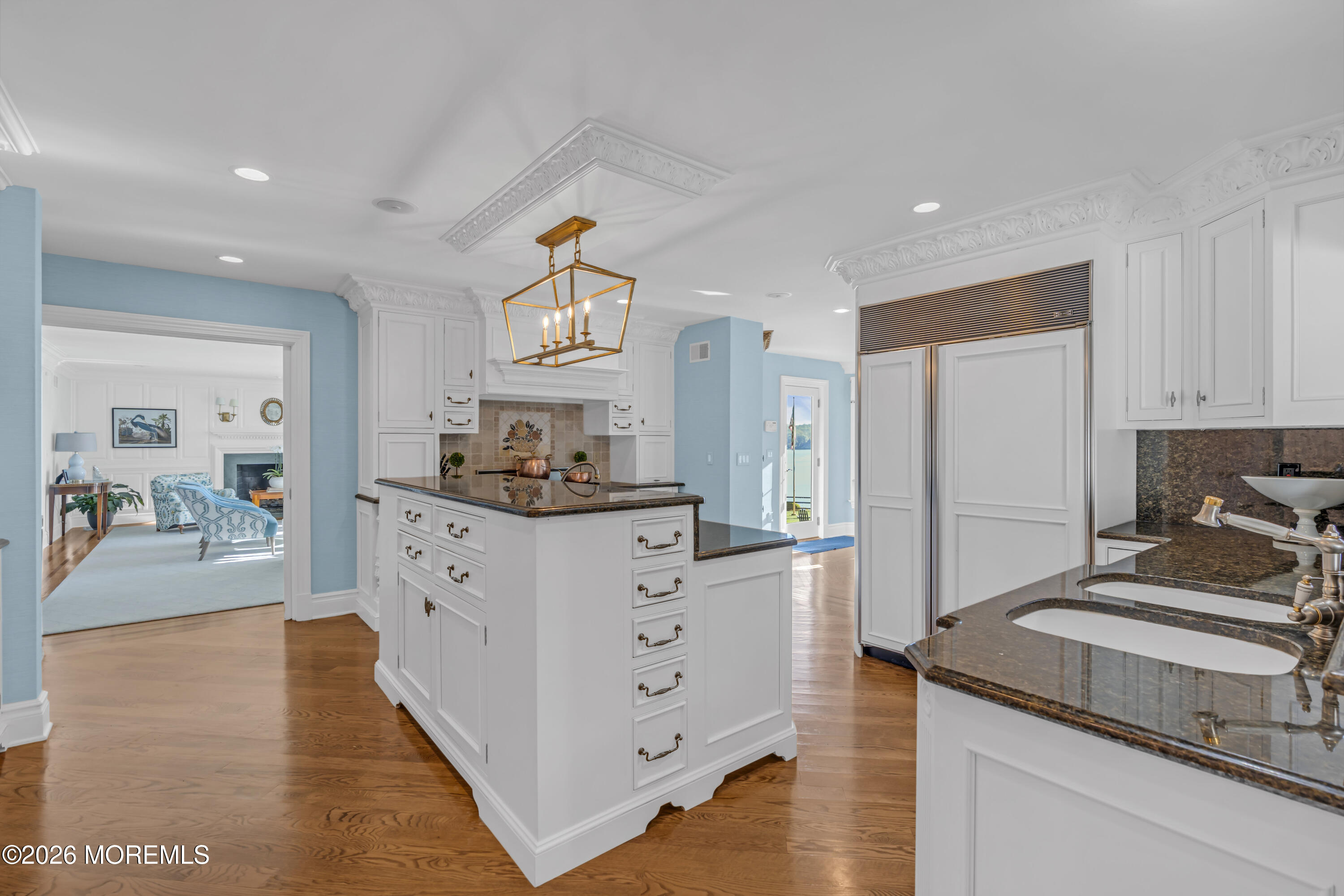 942 Navesink River Road Middletown, NJ 07760 - Photo 17 of 42 a kitchen with cabinets and wooden floor