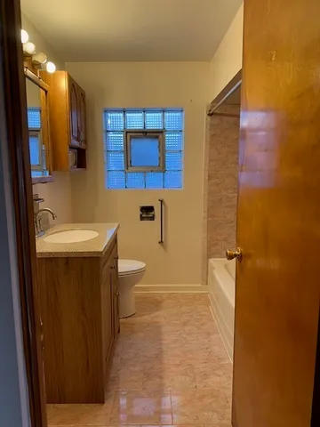 a bathroom with a sink a toilet and mirror