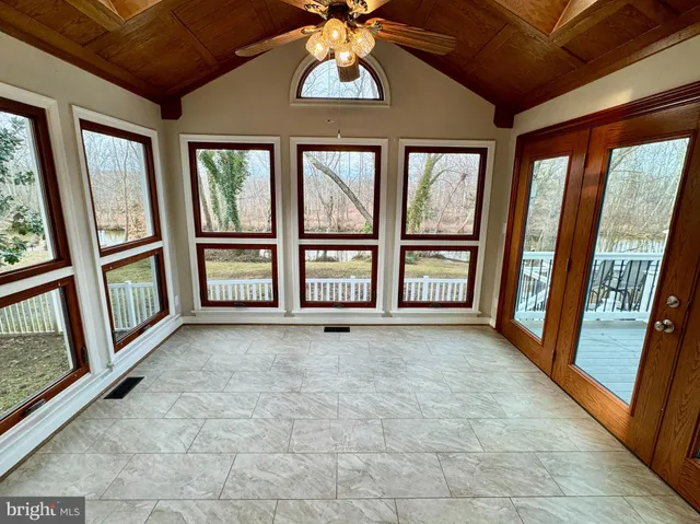 a view of a livingroom with a fireplace window and stairs