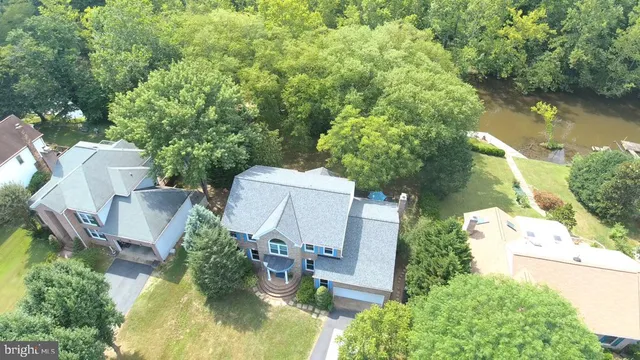an aerial view of a house with swimming pool and outdoor space