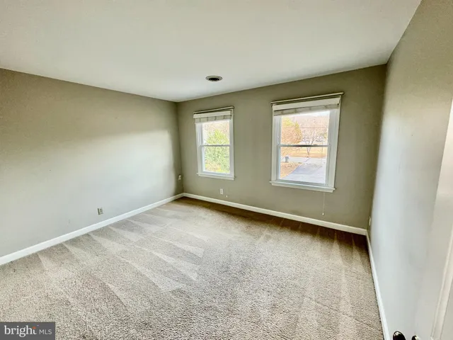 a view of a small house and a yard