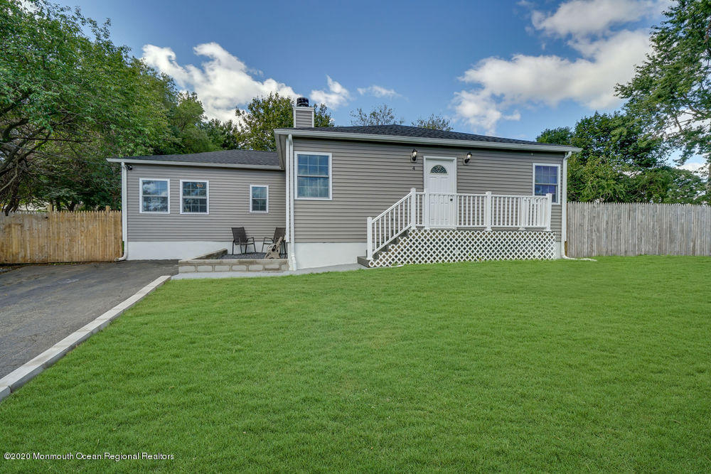 4 Nolan Road Morganville, NJ 07751 - Photo 1 of 46 a backyard of a house with table and chairs