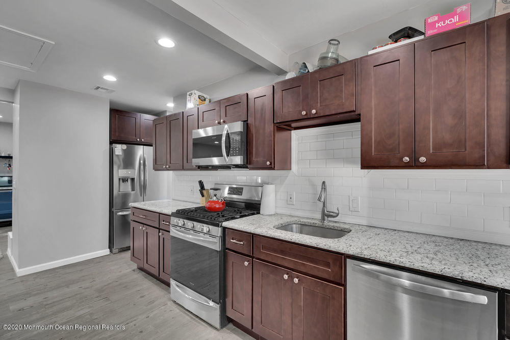 4 Nolan Road Morganville, NJ 07751 - Photo 18 of 46 a kitchen with stainless steel appliances granite countertop a sink stove and refrigerator