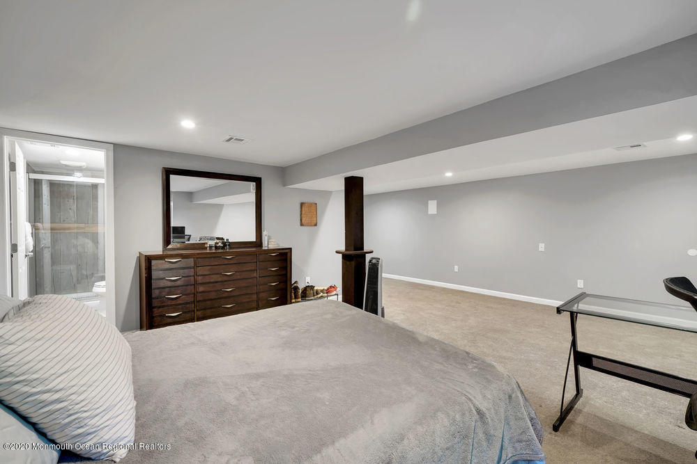 4 Nolan Road Morganville, NJ 07751 - Photo 23 of 46 a large bedroom with a bed and a large mirror