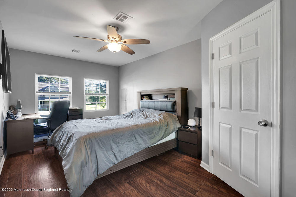 4 Nolan Road Morganville, NJ 07751 - Photo 28 of 46 a bedroom with a large bed and a chandelier
