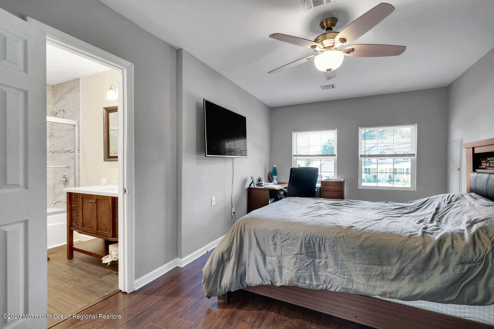 4 Nolan Road Morganville, NJ 07751 - Photo 30 of 46 a bedroom with a bed and a flat screen tv