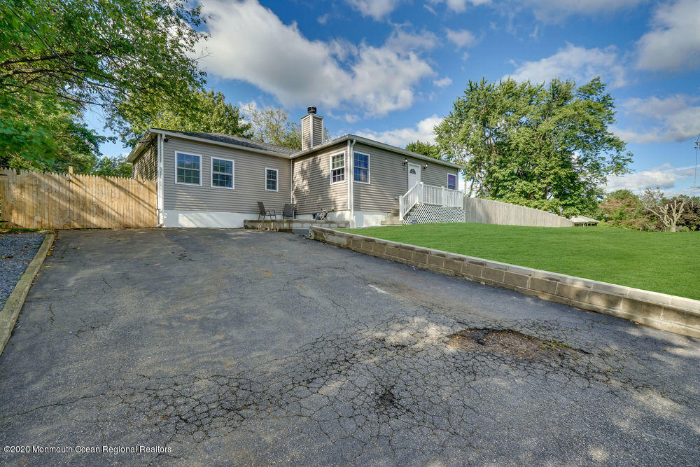 4 Nolan Road Morganville, NJ 07751 - Photo 3 of 46 a front view of a house with a yard and garage