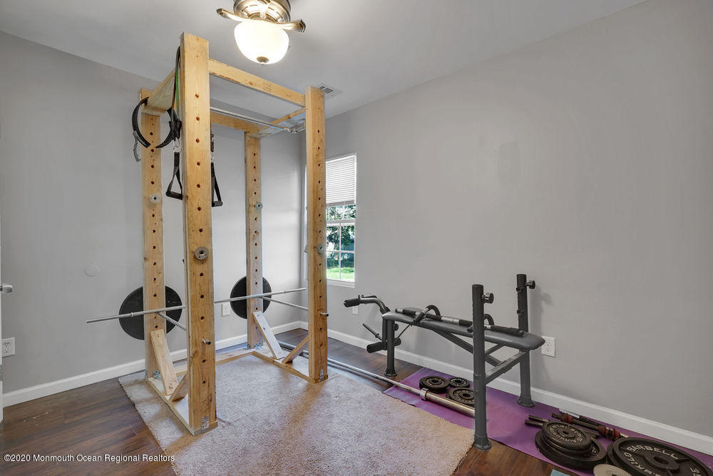 4 Nolan Road Morganville, NJ 07751 - Photo 32 of 46 a room with gym equipment and wooden floor