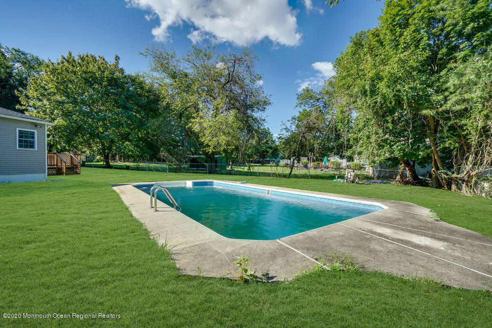 4 Nolan Road Morganville, NJ 07751 - Photo 37 of 46 a view of a swimming pool with a yard