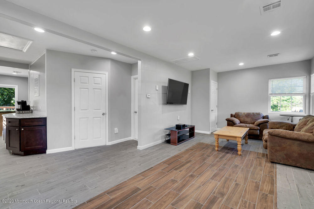 4 Nolan Road Morganville, NJ 07751 - Photo 7 of 46 a living room with furniture and a flat screen tv