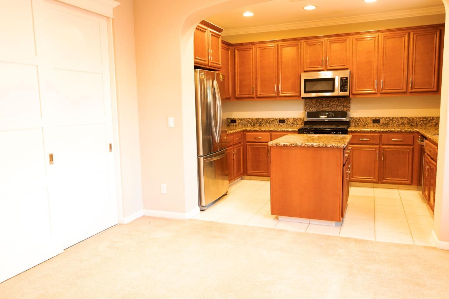 7754 Stoneleaf Road San Ramon, CA 94582 - Photo 14 of 25 a kitchen with stainless steel appliances a stove a microwave a sink and cabinets