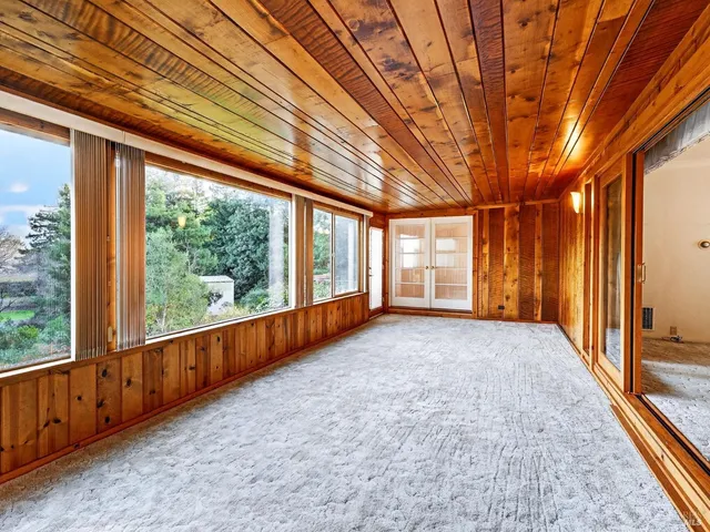 a view of a room with wooden walls and iron stairs