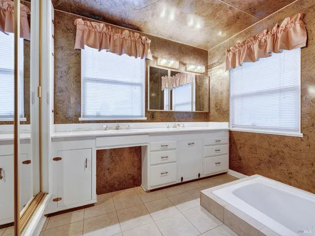 a bathroom with a sink a vanity and a mirror