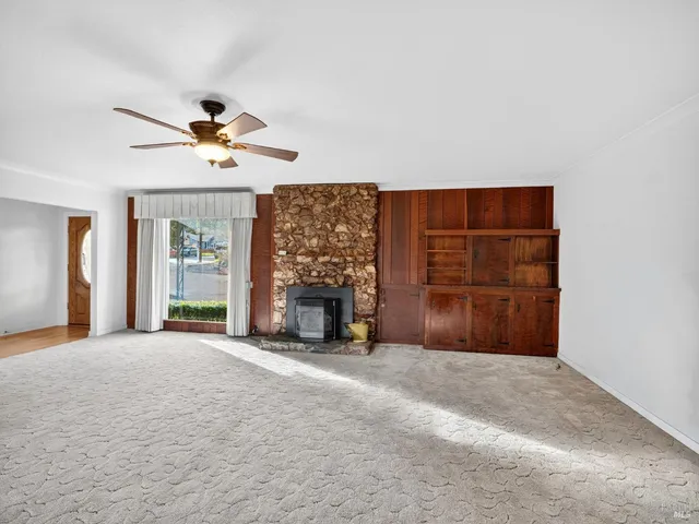 a view of a livingroom with a fireplace and a window