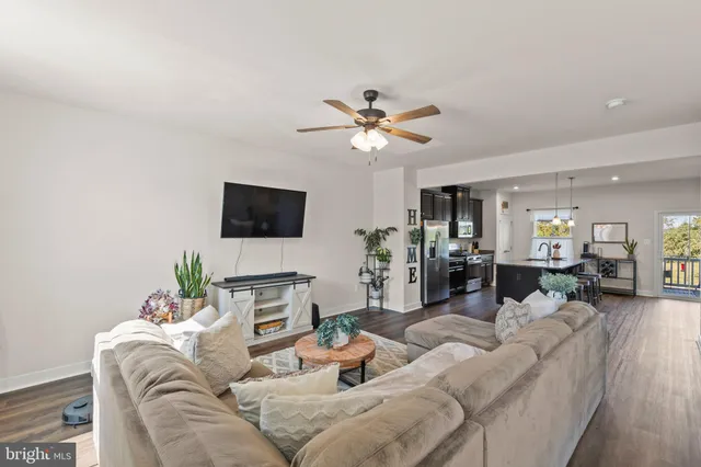 a living room with furniture windows and a wooden floor