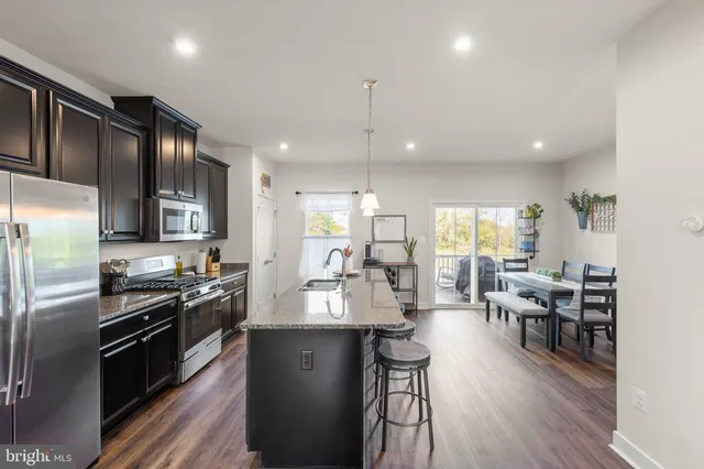 a living room with furniture a flat screen tv and a potted plant