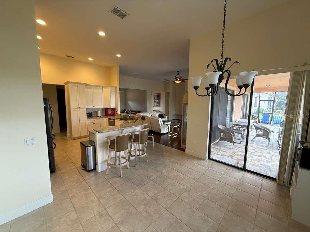 898 San Raphael Street Poinciana, FL 34759 - Photo 11 of 37 a view of a dining room with furniture a chandelier