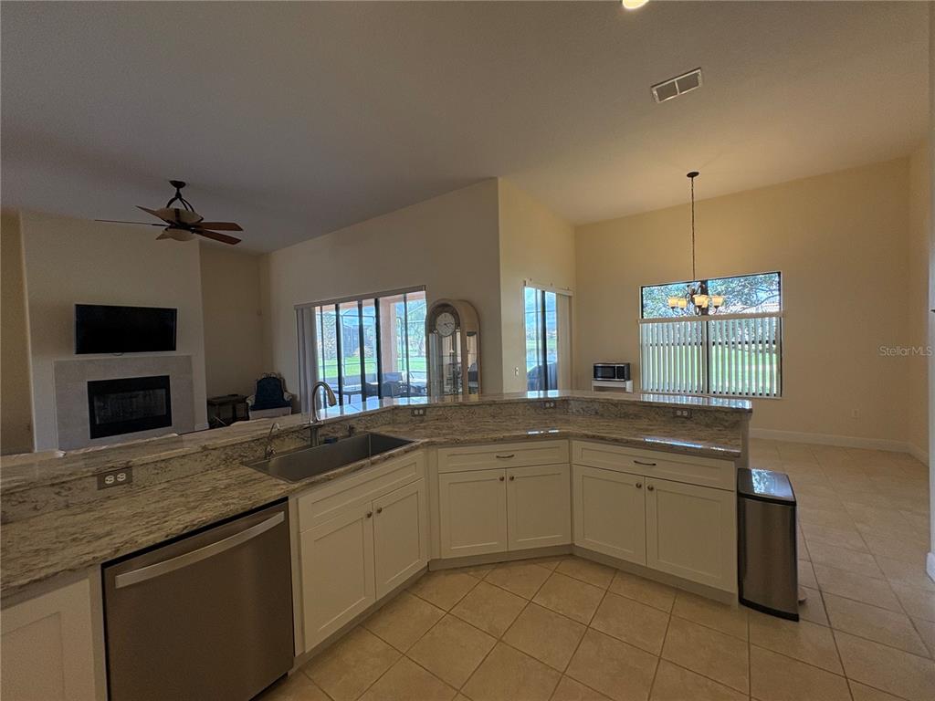 898 San Raphael Street Poinciana, FL 34759 - Photo 14 of 37 a kitchen with a sink and cabinets
